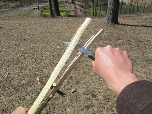 Vintage man using Knife for sharpening tines.