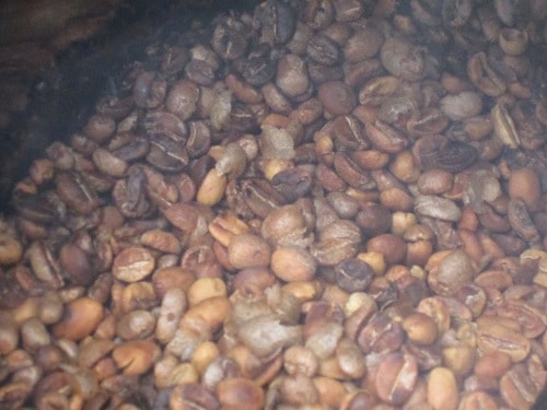 Coffee beans turning brown in the middle of roasting process.
