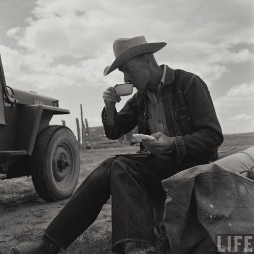 vintage man cowboy rancher sitting down drinking coffee 