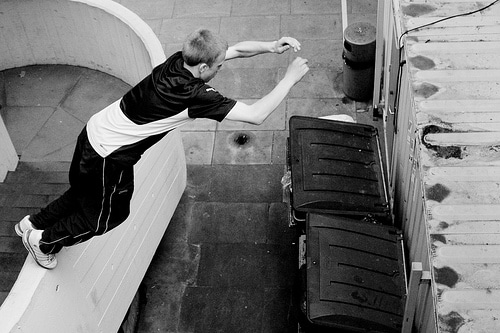 A boy jumping over gaps and obstacles.