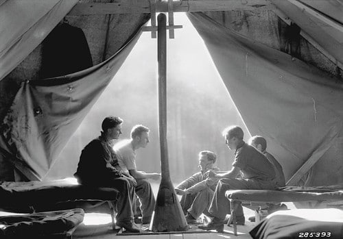 vintage soldiers in opening of army tent talking 