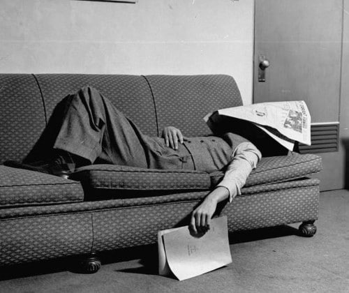 vintage man napping sleeping on couch newspaper on head