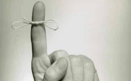 A black and white photo of a hand holding a string, showcasing the strength it imparts.