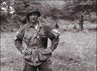 Forrest Guth, a passionate soldier in uniform, standing with willingness in a field.