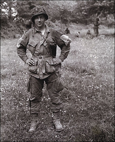 Forrest Guth, a passionate soldier in uniform, standing with willingness in a field.