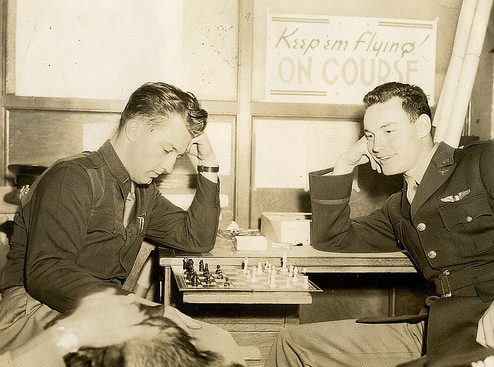 Vintage young men playing chess.