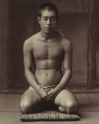 Vintage young man meditating kneeling.