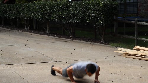 Vintage man laying on earth for pushups.