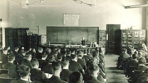 A group of scholars practicing classroom etiquette.