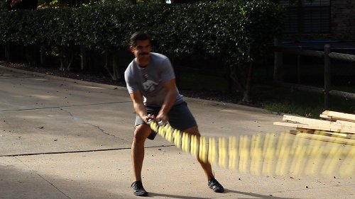 Vintage man moving his double arm for figure eight circles.