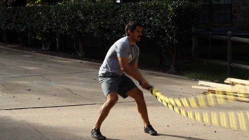 Vintage man moving his double arm for figure eight circles.