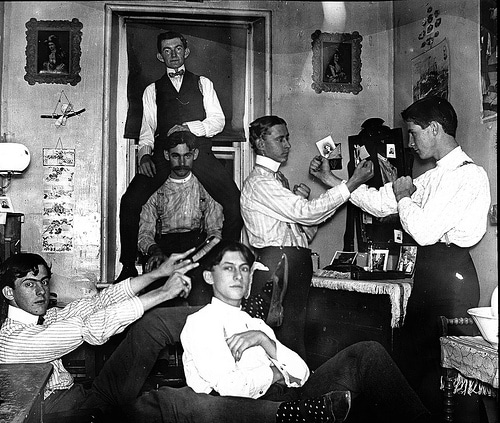 Vintage college students in dorm room taking funny goofy picture.