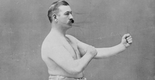 This black and white photo of a man with a mustache captures the essence of masculinity.