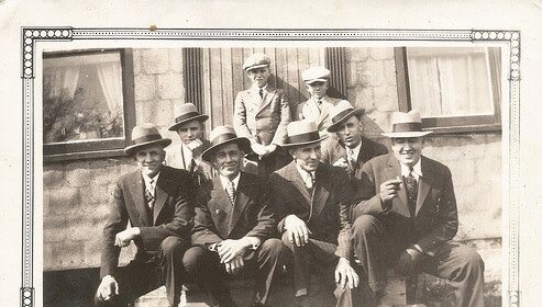 A manly group posing for a photo.