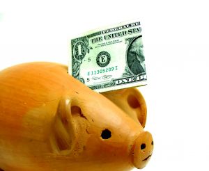 A piggy bank representing the concept of saving money with a dollar bill inside.