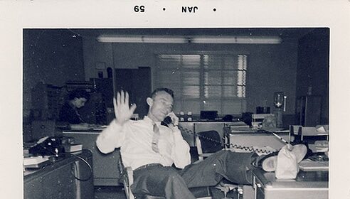 The go-to guy working diligently on his tasks in the office, determined to become successful.