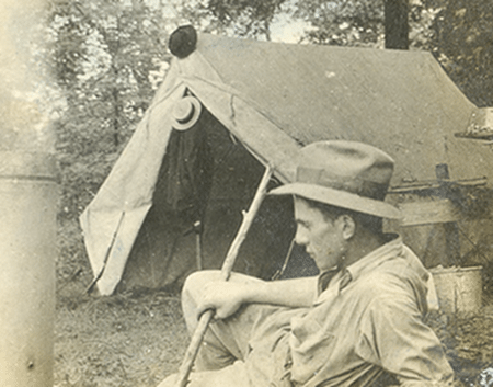 A man camping near a tent.