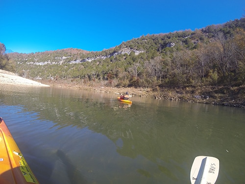 Yellow kayaks at the mid of water.