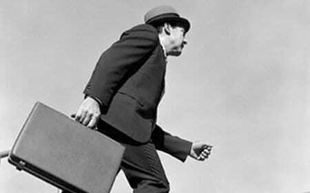 An ambitious man carrying a briefcase, showcasing his professional initiative.