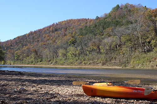 kayaks at the side of river.