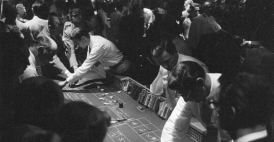 A group of people engaging in gambling at a casino.