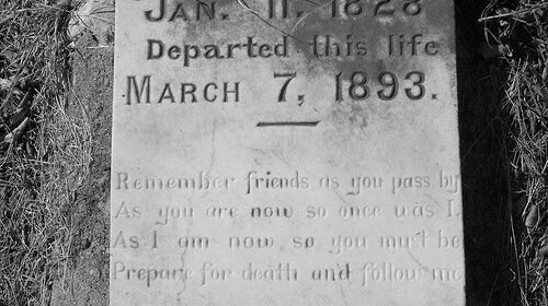 A hauntingly beautiful black and white photo capturing the solemnity of a gravestone.