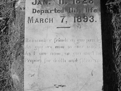A hauntingly beautiful black and white photo capturing the solemnity of a gravestone.