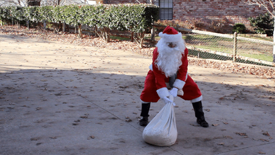 Strong Santa Claus Lift Barbell of Red Bag Gifts. Powerful Old M