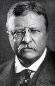 An old photo of Theodore Roosevelt, a man with glasses and a mustache.