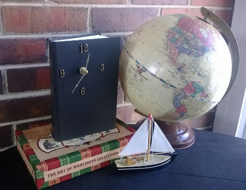 A clock next to a book