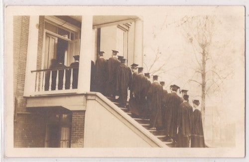 A group of graduates performing a ritual on the steps of a house, symbolizing personal change and the power within.