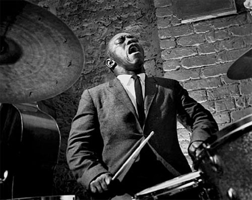 Art Blakey jazz musician playing drums singing.