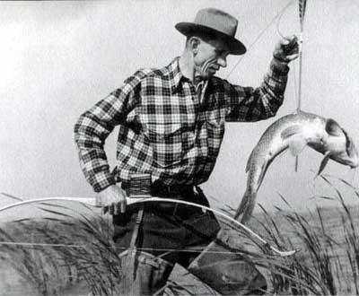 Vintage man with bow and arrow fishing fish caught.