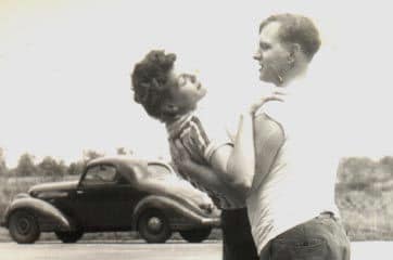 Vintage man holding a women in his arms.