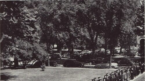 An introduction to college for everyone captured in a black and white photo of a group of people in graduation gowns.