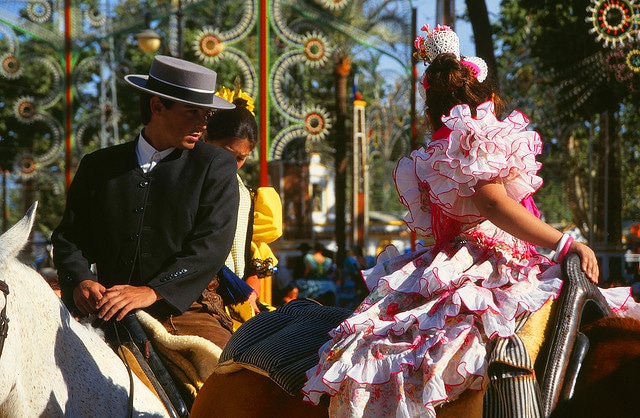 andalusian man with straight brimmed fedora looking at woman