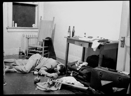 After drunk a Vintage college man passed on dorm room floor.