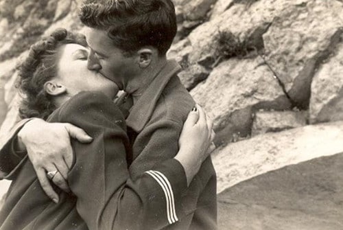 Vintage couple kissing passionately outside. 