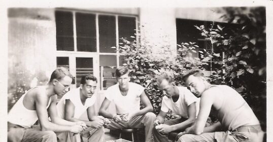 A group of men gathering to review and discuss manhood while sitting around a pot.