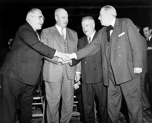 Vintage group of men meeting shaking hands.