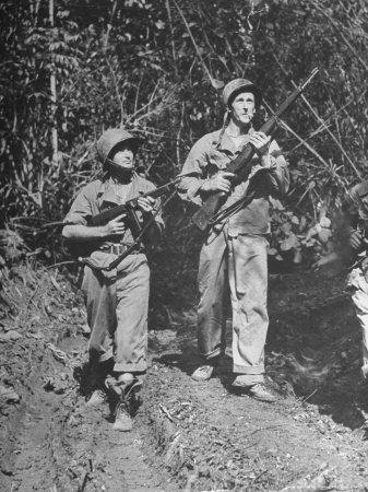 Vintage soldiers walking in forest. 