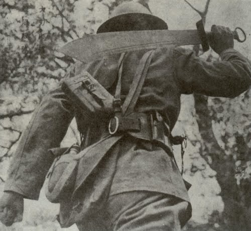 Vintage soldier carrying machete on shoulder. 