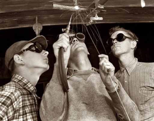 Men welding with safety glasses.