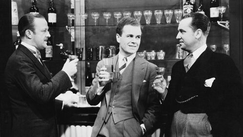 Three men responsibly enjoying drinks at the bar.