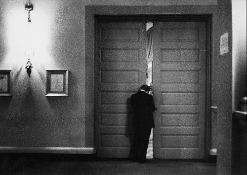 Vintage man opening hall door. 