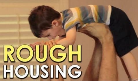 During a roughhousing session, Dr. Anthony DeBenedet playfully holds a child up to his head.