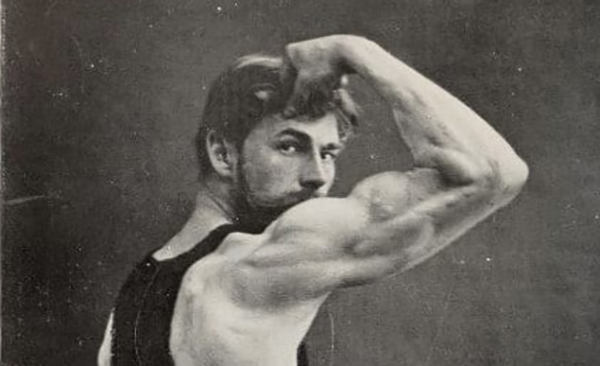An old photo of a man showcasing his physical vigor by flexing his muscles.