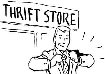 A man in a suit is adjusting his tie in front of an inexpensive thrift store.