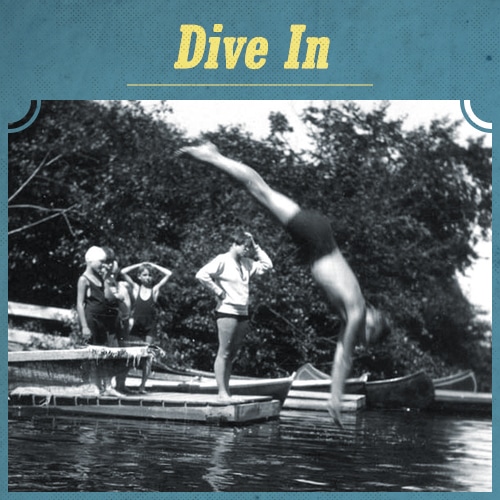 Vintage men diving into river from dock. 