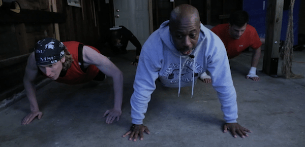 Men in garage doing push ups home fight club.